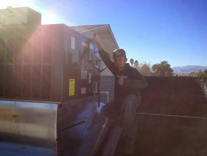 HVAC technician performing Boiler Repair on a rooftop unit in Fairlawn